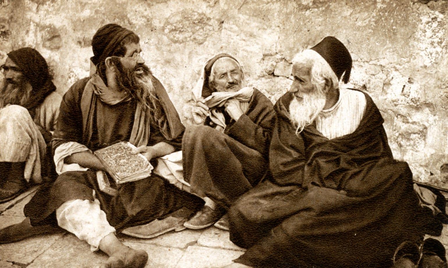 זקנים יושבים על ספר בירושלים